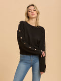 Maglia con bottoni sulle maniche